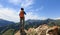 Hiker stand at cliff edge on mountain top