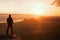 Hiker stand on the sharp corner of sandstone rock in rock empires park and watching over the misty and foggy morning valley to Sun