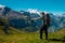 Hiker standing on the Bernese Oberland hiking ridge with mountain landscape in Switzerland