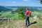 Hiker standing at a cliff and looking at scenic landscape