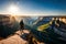 A hiker standing on the edge of a cliff, gazing out at a vast canyon beneath a clear blue sky