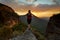 Hiker standing firm on narrow ledge  in wilderness mountains