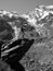 hiker standing over a large rock looks at Monte Rosa, Macugnaga, Italy