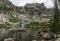 Hiker standing on a rock at Amphitheater Lake