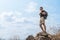 Hiker standing on rock during walking on trekking trail on mountain