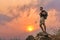 Hiker standing on rock during walking on trekking trail on mountain