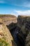 Hiker on steep cliffs at Duncansby Head in Scotland