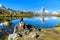 Hiker at Stellisee - beautiful lake with reflection of Matterhorn - Zermatt, Switzerland
