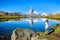 Hiker at Stellisee - beautiful lake with reflection of Matterhorn - Zermatt, Switzerland