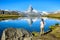 Hiker at Stellisee - beautiful lake with reflection of Matterhorn - Zermatt, Switzerland