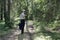 Hiker stops on a forest trail and turns to someone