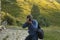 A hiker takes photos with a camera, Aragonese Pyrenees, Spain