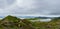 Hiker on top of a mountain overlooking Loch Leathan, Isle of Skye