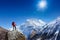 Hiker at the top of a rock with backpack enjoy sunny day