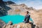Hiker traveler at the mountain lake. Turquoise lake in the mountains.