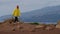 Hiker traveler woman walking in rocky top mountain in the jacket and the bottom of the shirt. Rock climbing outdoors