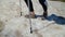 Hiker with trekking poles on snowy hillside