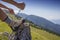 Hiker tying boot laces, high in the mountains