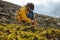 Hiker tying boot laces on the mountain