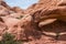 Hiker under La Boca Arch Utah