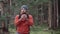 Hiker use smartphone for navigation in woods during autumn outdoor hiking expedition. Traveler using GPS navigational