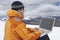 Hiker Using Laptop On Snowy Mountain Landscape