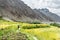 Hiker walking along the wheat fields near Hushe village, Gondogoro La trek, Gilgit-Baltistan, Pakistan