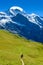 Hiker walking in beautiful mountain scenery at Grindelwald and Jungfrau - Switzerland