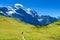 Hiker walking in beautiful mountain scenery at Grindelwald and Jungfrau - Switzerland