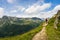 Hiker walking on a beautiful path in Aiguilles Rouges