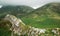 Hiker walking on cliff wall.