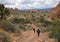 Hiker walking down a trail at the Devils Garden at Arches National Park in Moab Utah.