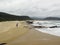 Hiker walking on Nature`s Valley Beach on Garden Route, South Africa