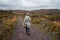 Hiker walking through rugged wild landscape