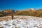 Hiker walking on Snow Slope Trail Mountains View