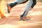 Hiker walking throught sandy desert. Traces in sand. Focus on a man legs. Tourist in a desert. Sandy background.