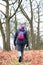 A hiker walks along a trail during winter