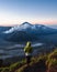 Hiker Watches Sunrise over Mount Bromo, Java, Indonesia