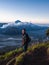 Hiker Watches Sunrise over Mount Bromo, Java, Indonesia