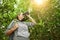 Hiker watching through binoculars wild birds in the jungle