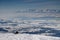 Hiker watching Tatra peaks above snowy plains in mist in Poland