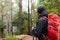 Hiker wearing hiking backpack and hardshell jacket