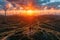 Hiker witnessing sunset amid wind farm landscape