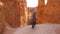 Hiker Woman Begins Goes Down The Route Near The Rock Wall Of The Bryce Canyon