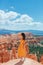 Hiker woman in Bryce Canyon resting enjoying view in beautiful nature landscape with hoodoos, pinnacles and spires rock