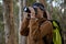 Hiker woman clicking a photo in forest