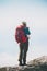 Hiker woman on cliff mountains with backpack