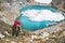 Hiker woman climbing at blue lake heart shaped