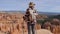 Hiker Woman Comes To Edge, Looks Forward To The Bryce Canyon And Turns Around