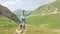 Hiker woman enjoy beautiful mountain landscape and make photo to mobile phone